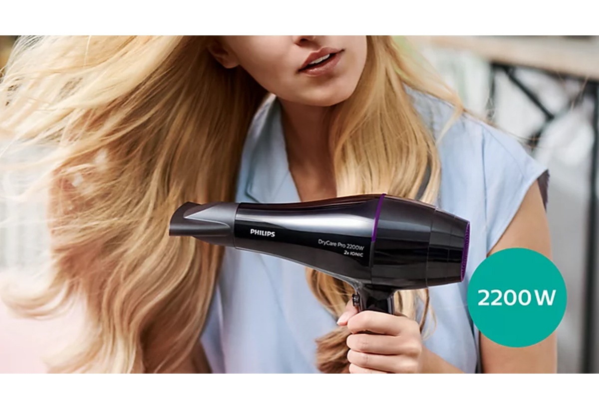 Μια γυναίκα στεγνώνει τα μαλλιά της.